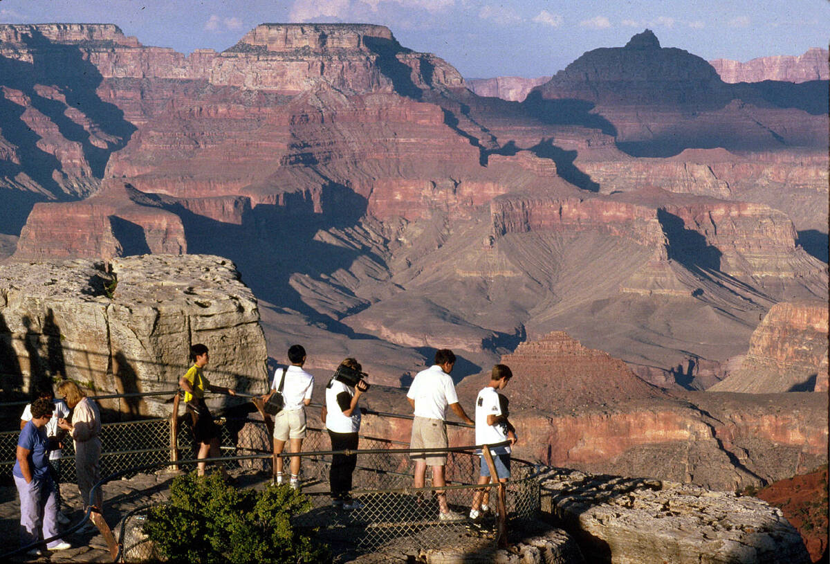 Visitors view the Grand Canyon from Mather Point on the South Rim at Grand Canyon National Park ...