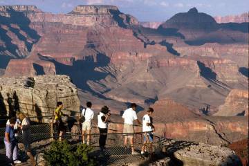 Visitors view the Grand Canyon from Mather Point on the South Rim at Grand Canyon National Park ...