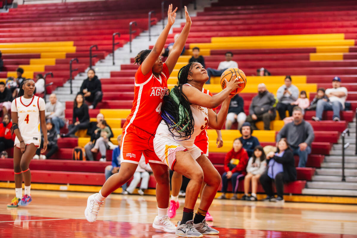 Del Sol power forward Morgan White fights for an opening to shoot the ball during a high school ...