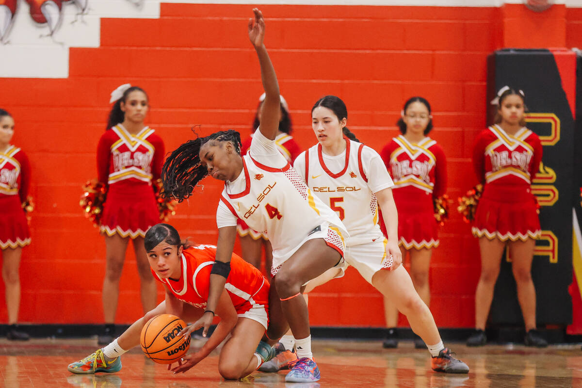 Ge Ge Pickens (4) get into a scuffle for the ball during a high school basketball game between ...