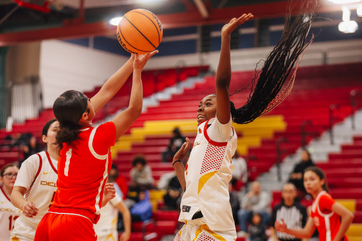 Ge Ge Pickens (4) battle for the ball during a high school basketball game between Del Sol and ...
