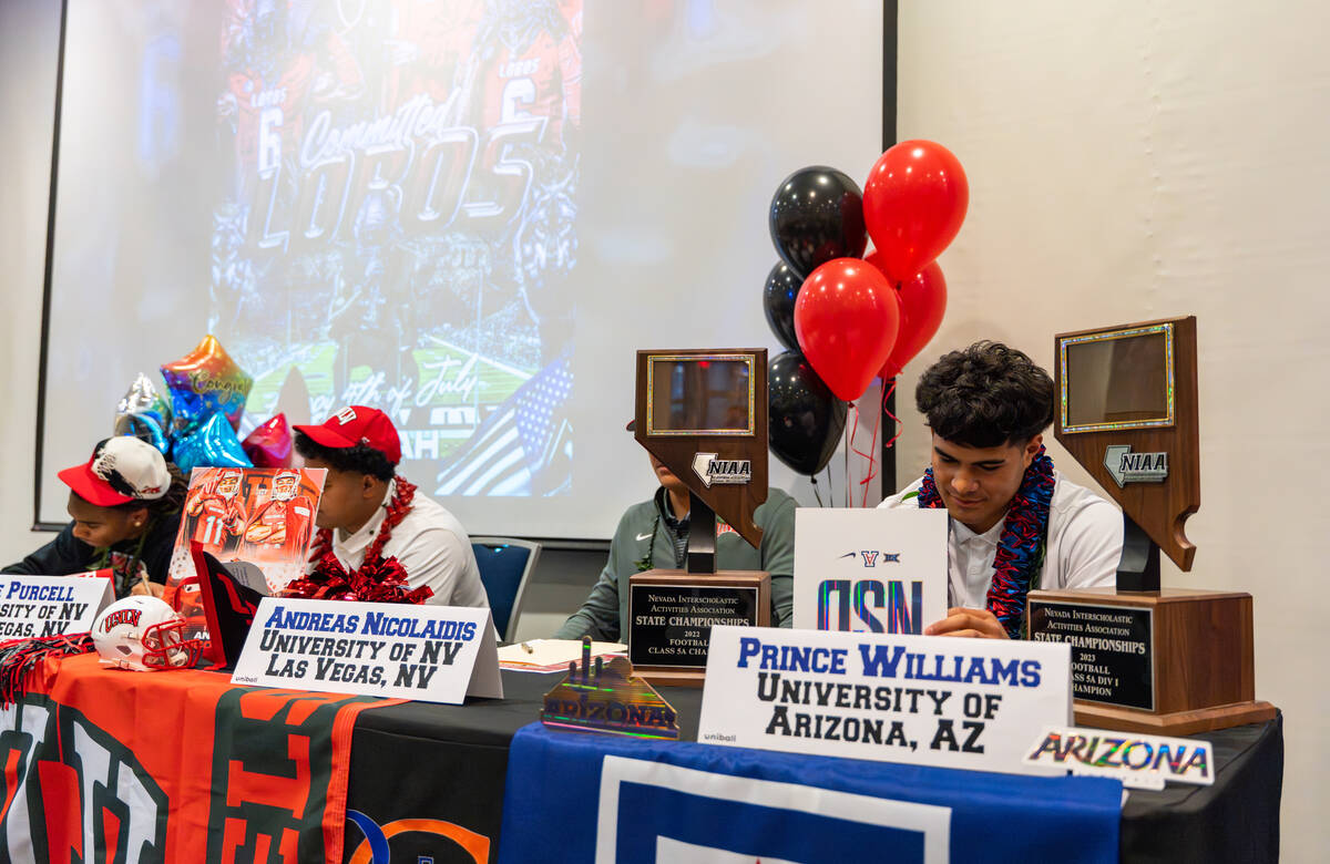 Prince Williams signs his offer letter to play football at the University of Arizona at Bishop ...