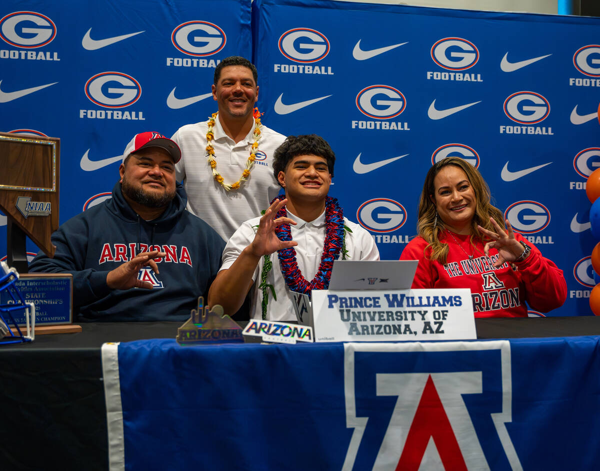Prince Williams poses for a photo with his coach and family after signing his offer letter to p ...