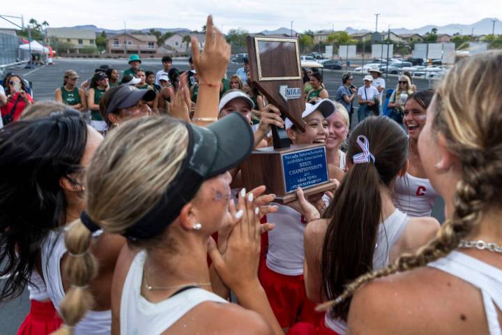 Coronado players celebrate the team victory with their trophy over Palo Verde winning the 5A gi ...