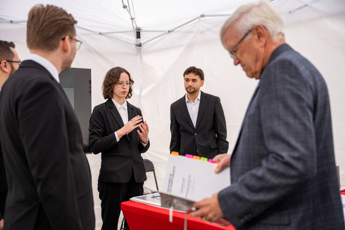 Alyssa Surette presents her team’s Waste to Watts project to a group of VIPs during the Fred ...