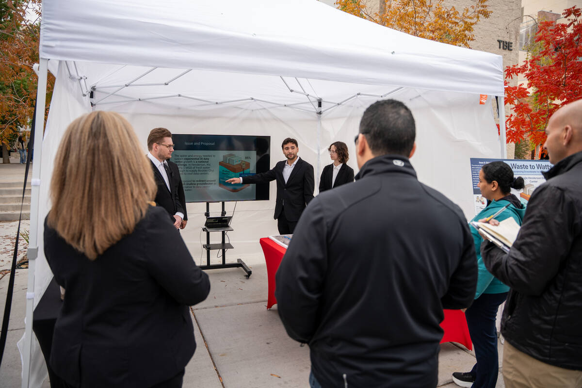 Adrian Montenegro presents his team’s Waste to Watts project to a group of judges during the ...