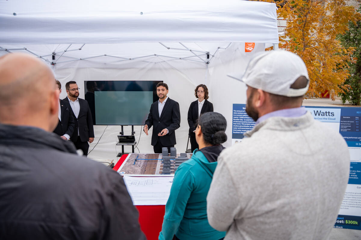 Adrian Montenegro presents his team’s Waste to Watts project to a group of judges during the ...