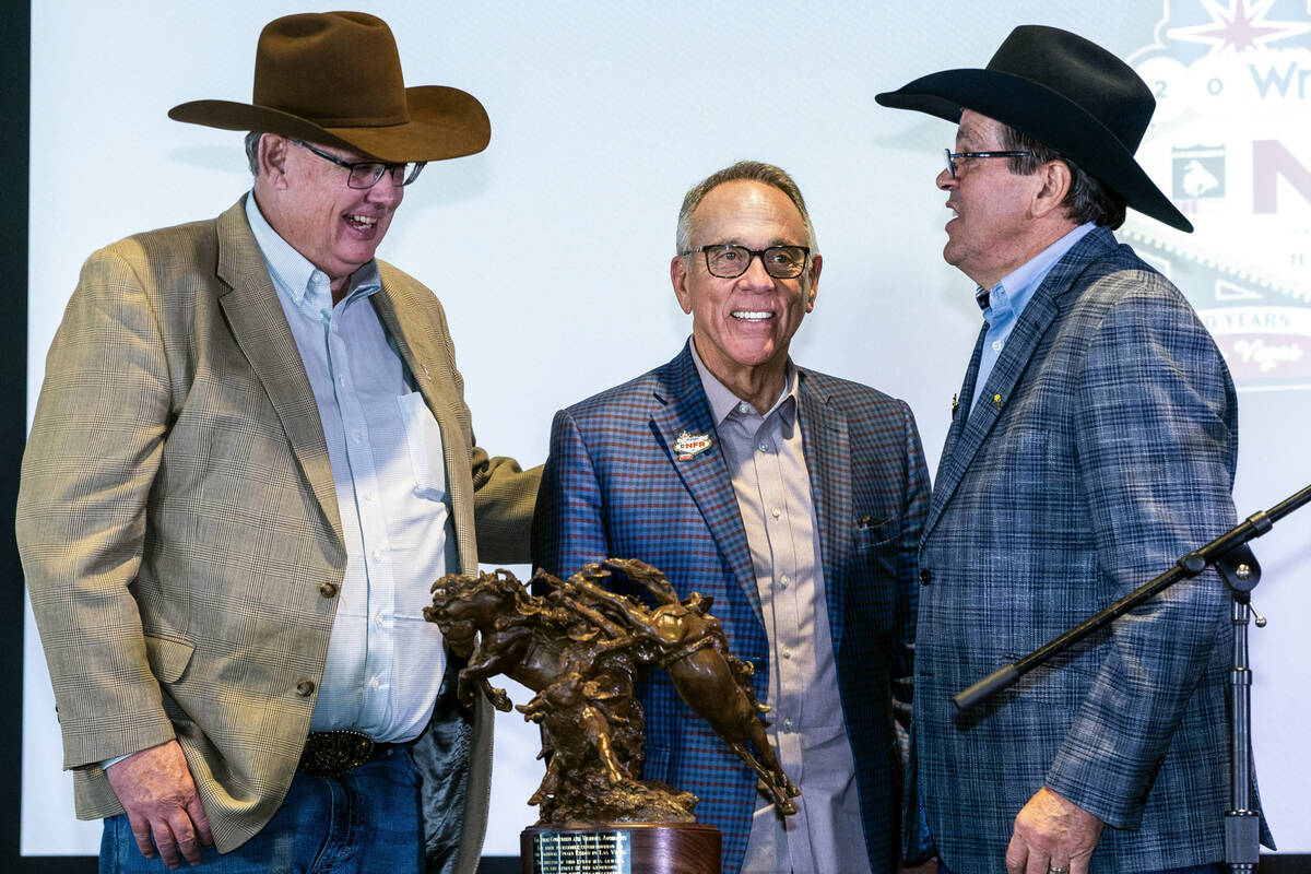 Tom Clause, Jim Gibson and Tim Keener unveil a sculpture presented to the Las Vegas Convention ...