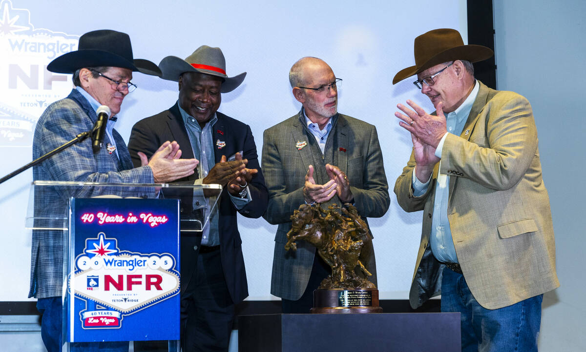 Tim Keener, Erick Harper, Chris Heavey and Tom Clause unveil a sculpture presented to the Thoma ...