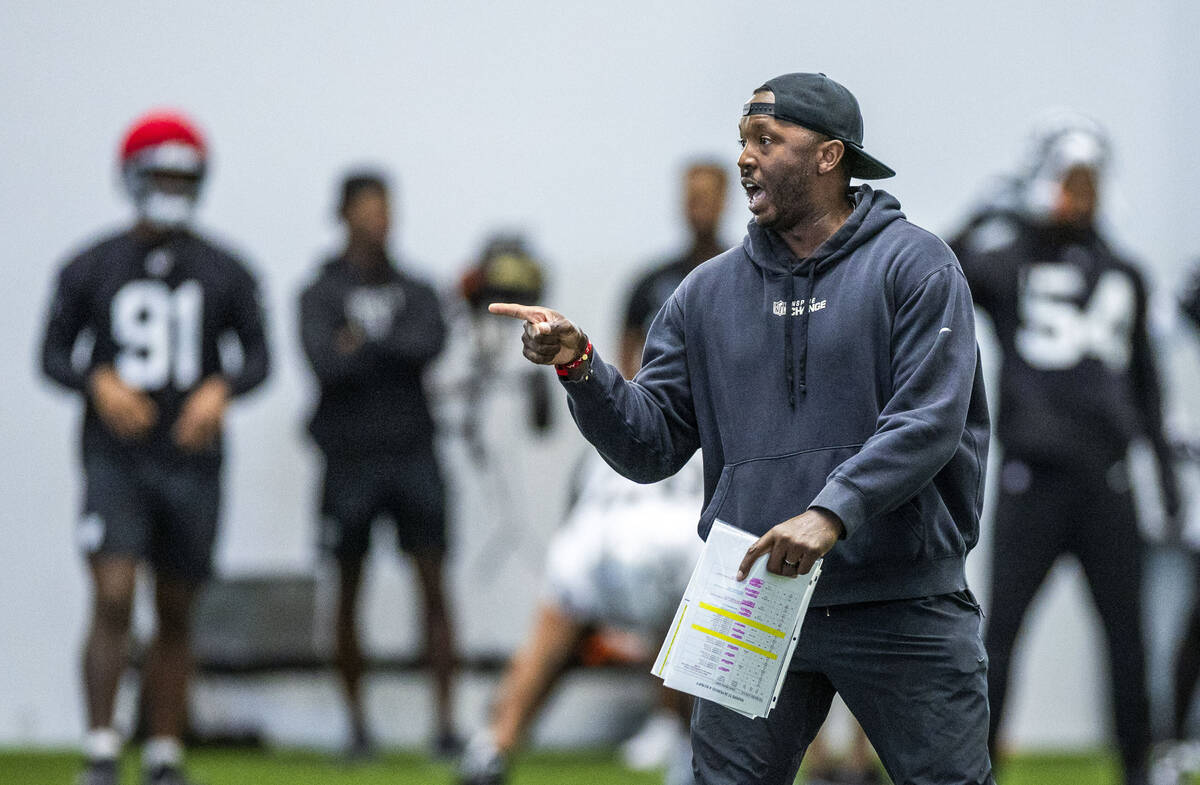 Raiders Derius Swinton II, special team assistant, works with the punt team during practice at ...