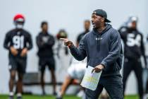 Raiders Derius Swinton II, special team assistant, works with the punt team during practice at ...