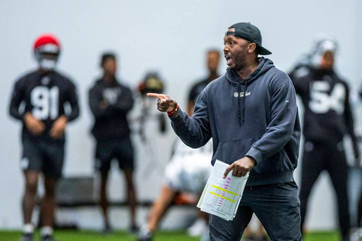 Raiders Derius Swinton II, special team assistant, works with the punt team during practice at ...
