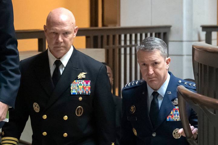 U.S. Navy Adm. Frank M. Bradley, accompanied by Gen. Dan Caine, chairman of the Joint Chiefs of ...