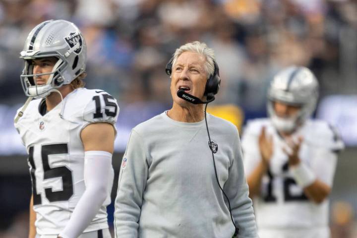 Raiders head coach Pete Carroll reacts to a penalty with quarterback Kenny Pickett (15) walking ...
