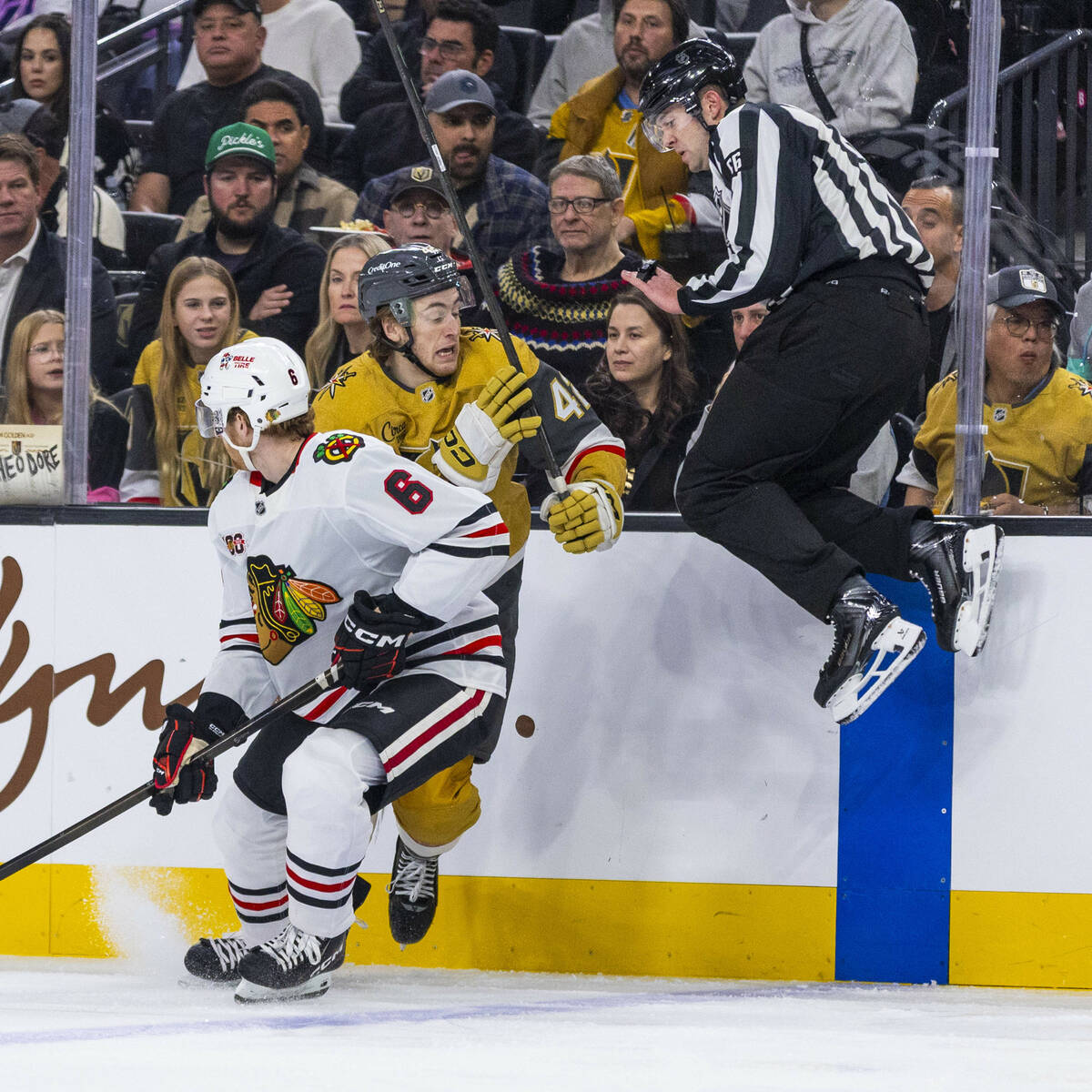 Golden Knights right wing Braeden Bowman (42) looks to evade an official leaping up to avoid th ...