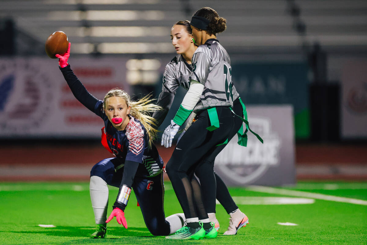 Coronado wide receiver Micah Weiss signals that she has the ball during a high school flag foot ...