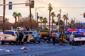 Metropolitan Police officers work with North Las Vegas firefighters as numerous vehicles are in ...