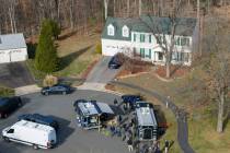 Prince William County Police block the street near the house where the FBI made an arrest, in W ...