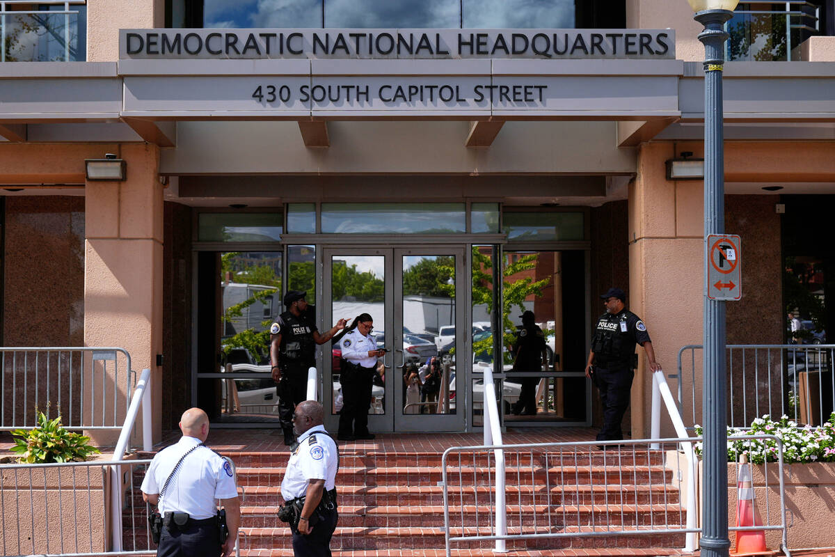 FILE - Members of law enforcement are pictured outside Democratic National Committee headquarte ...