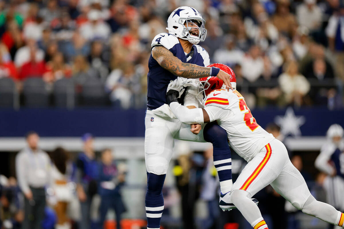 Dallas Cowboys quarterback Dak Prescott (4) is hit as he throws by Kansas City Chiefs safety Ch ...