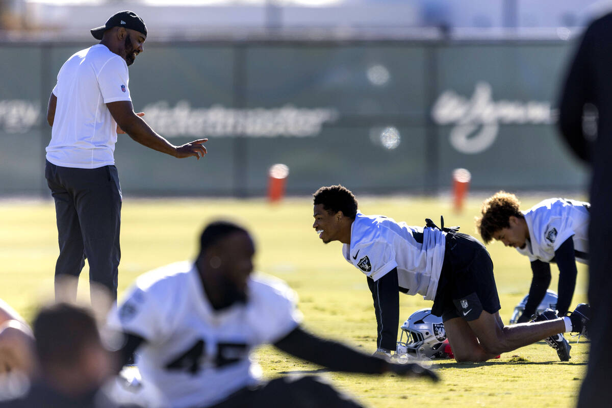 Raiders defensive quality control coach Beyah Rasool, left, works with cornerback Greedy Vance ...