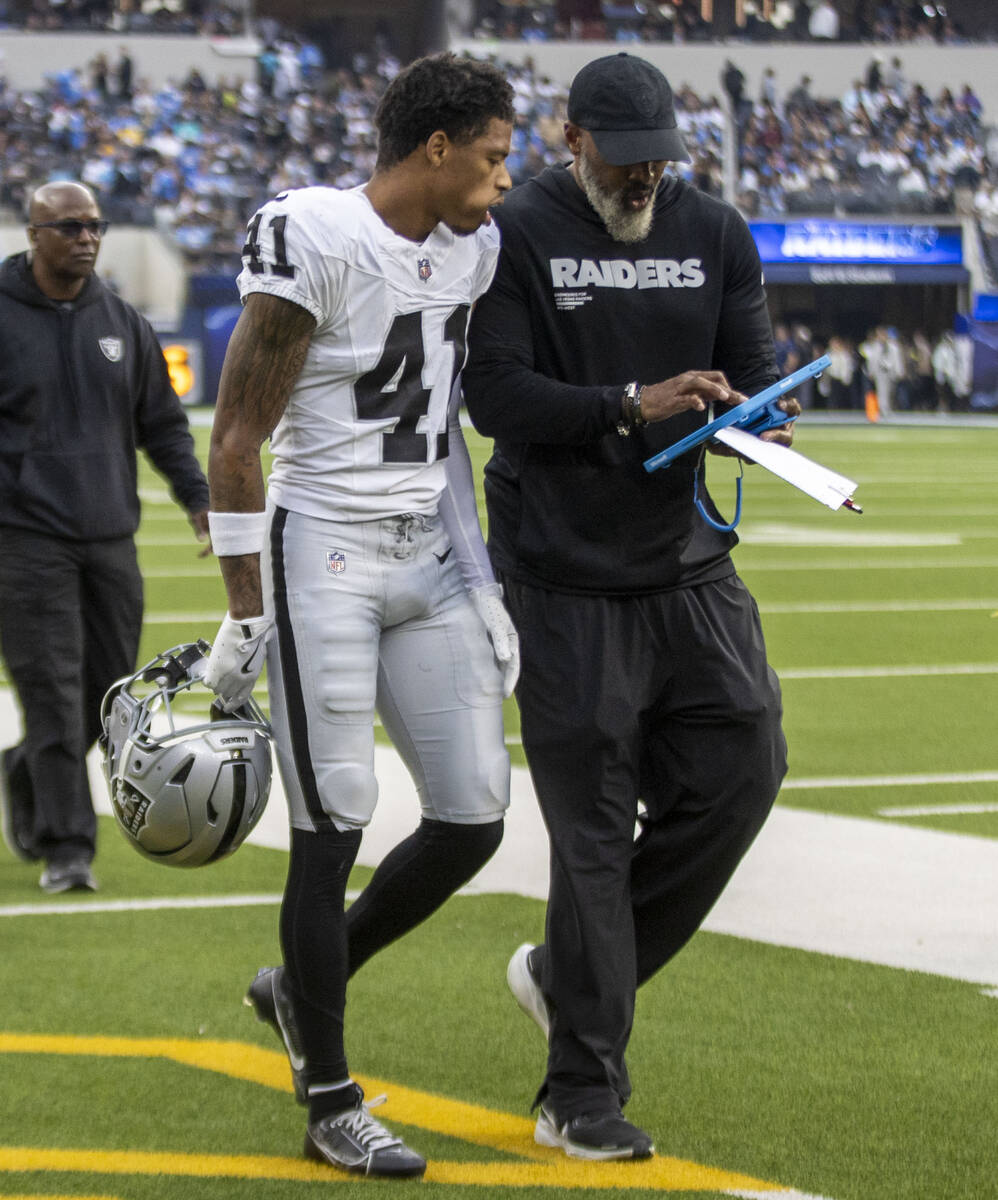 Raiders cornerback Greedy Vance (41) gets instruction from defensive backs coach Marcus Roberts ...