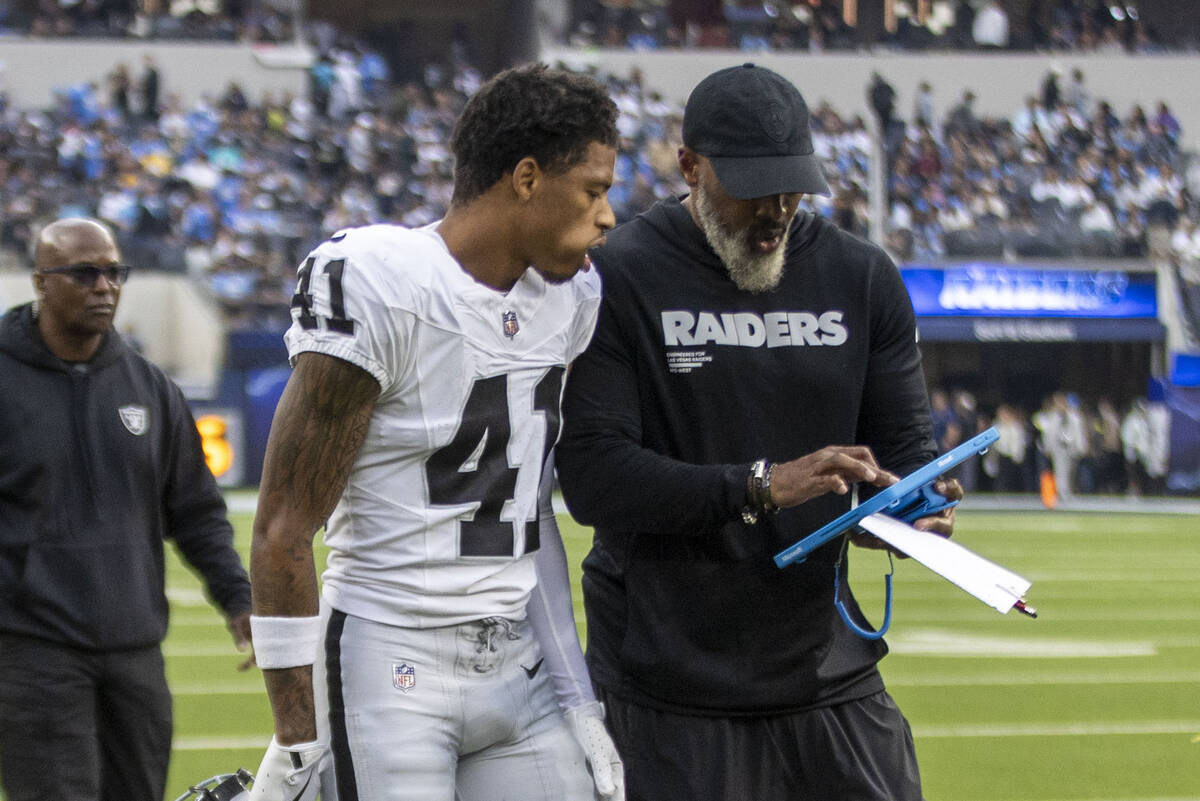Raiders cornerback Greedy Vance (41) gets instruction from defensive backs coach Marcus Roberts ...