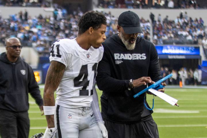Raiders cornerback Greedy Vance (41) gets instruction from defensive backs coach Marcus Roberts ...