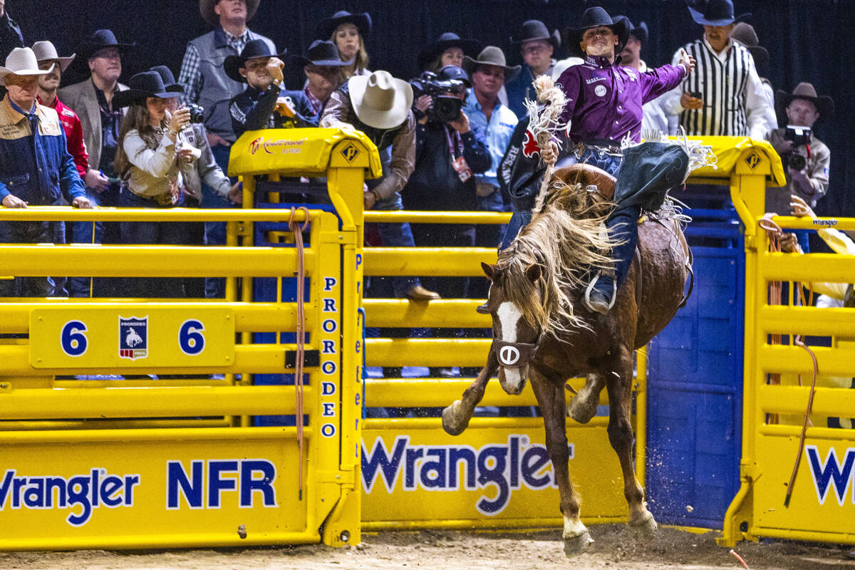 Damian Brennan rides R. Watson's Prairie Fire for a win in Saddle Bronc Riding during Day ...