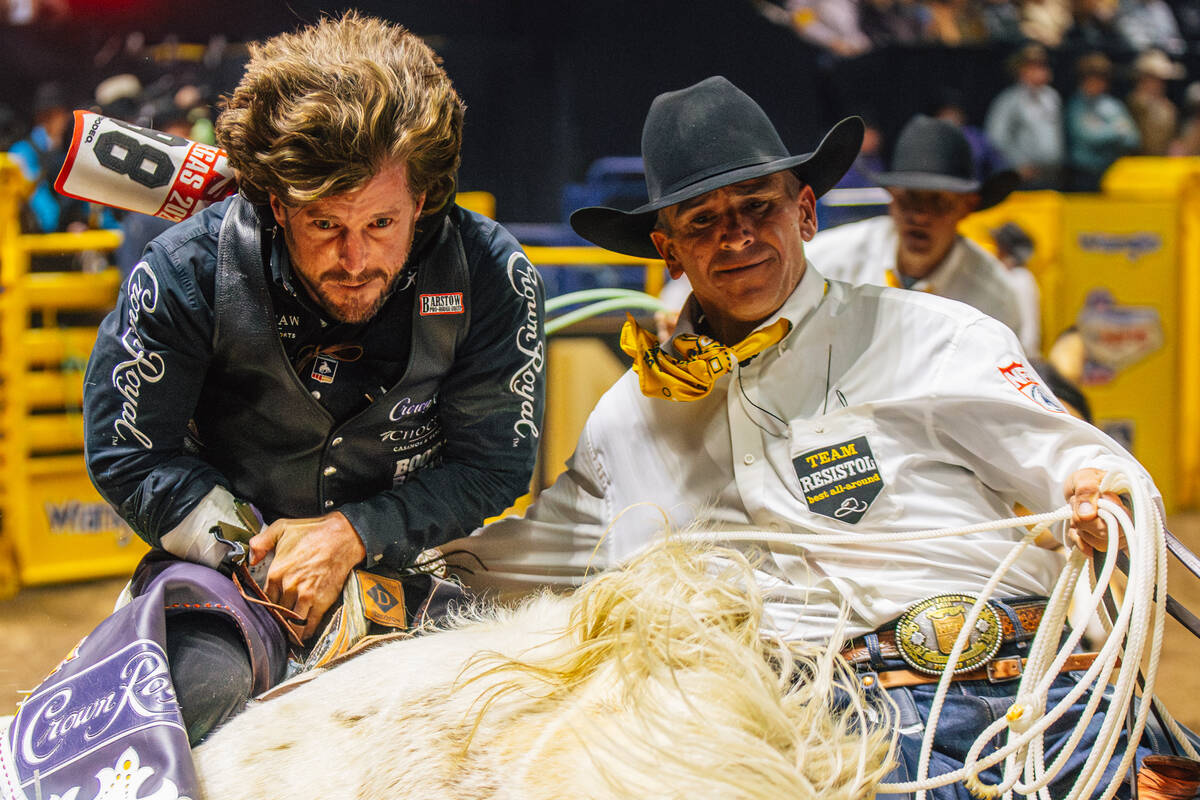 Tilden Hooper gets help getting off his ride from a pickup man during day three of the National ...