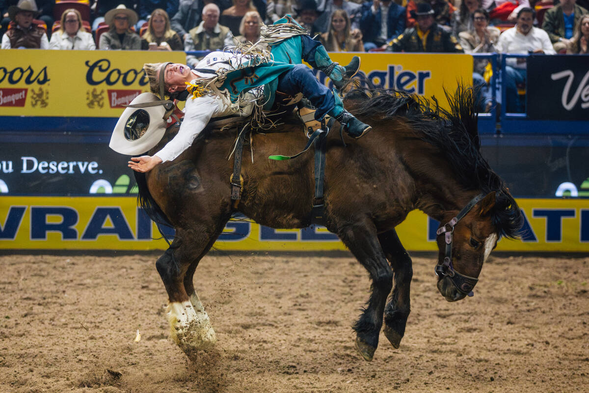 Sam Petersen loses his hat on Wild Rose during day three of the National Finals Rodeo at the Th ...