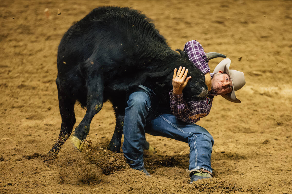 Tyler Waguespack wrestles the steer during day three of the National Finals Rodeo at the Thomas ...