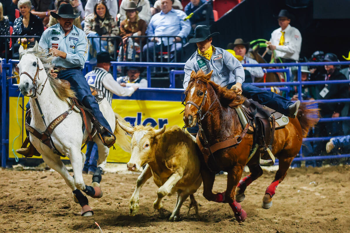 Gavin Soileau hops off his horse during steer wrestling during day three of the National Finals ...