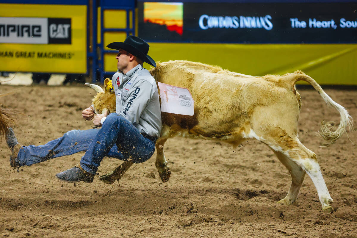 Jesse Brown catches air during steer wrestling during day three of the National Finals Rodeo at ...