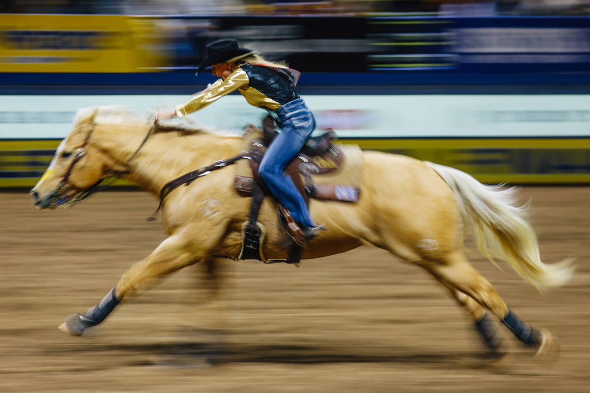 Carlee Otero speeds out of the arena during day three of the National Finals Rodeo at the Thoma ...