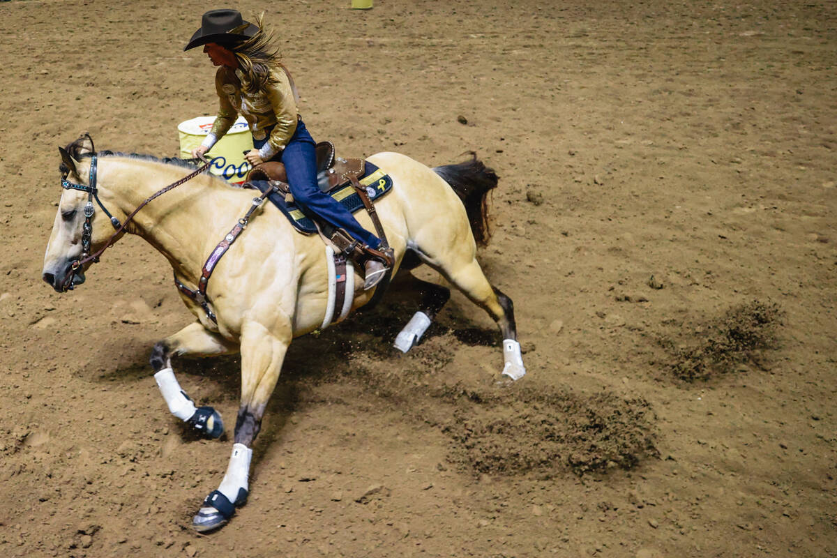 Andrea Busby rounds the first barrel during day three of the National Finals Rodeo at the Thoma ...