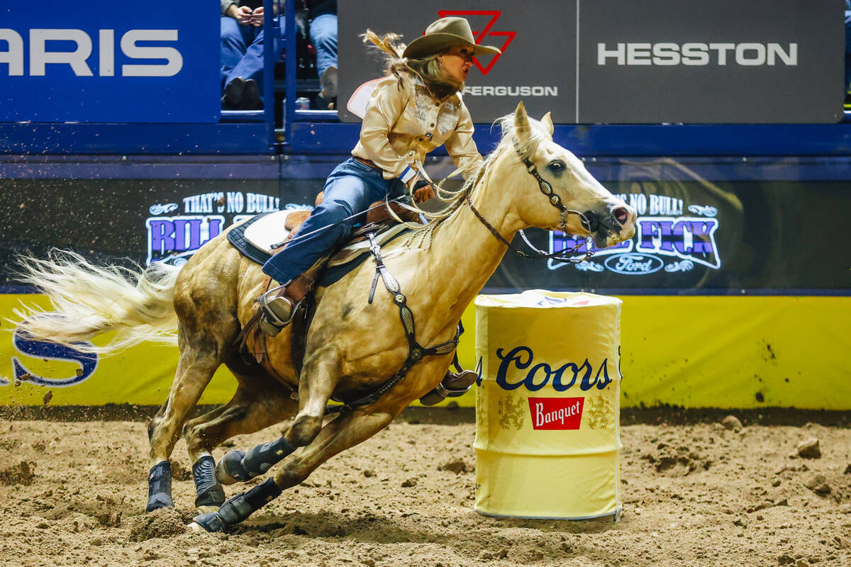 Katelyn Scott rounds a barrel during day three of the National Finals Rodeo at the Thomas & ...