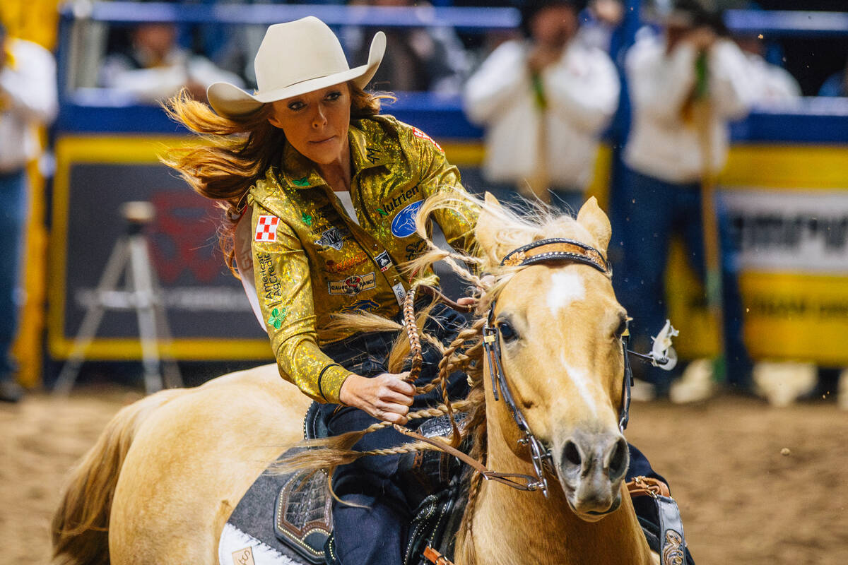 Emily Beisel rides into the arena during day three of the National Finals Rodeo at the Thomas & ...