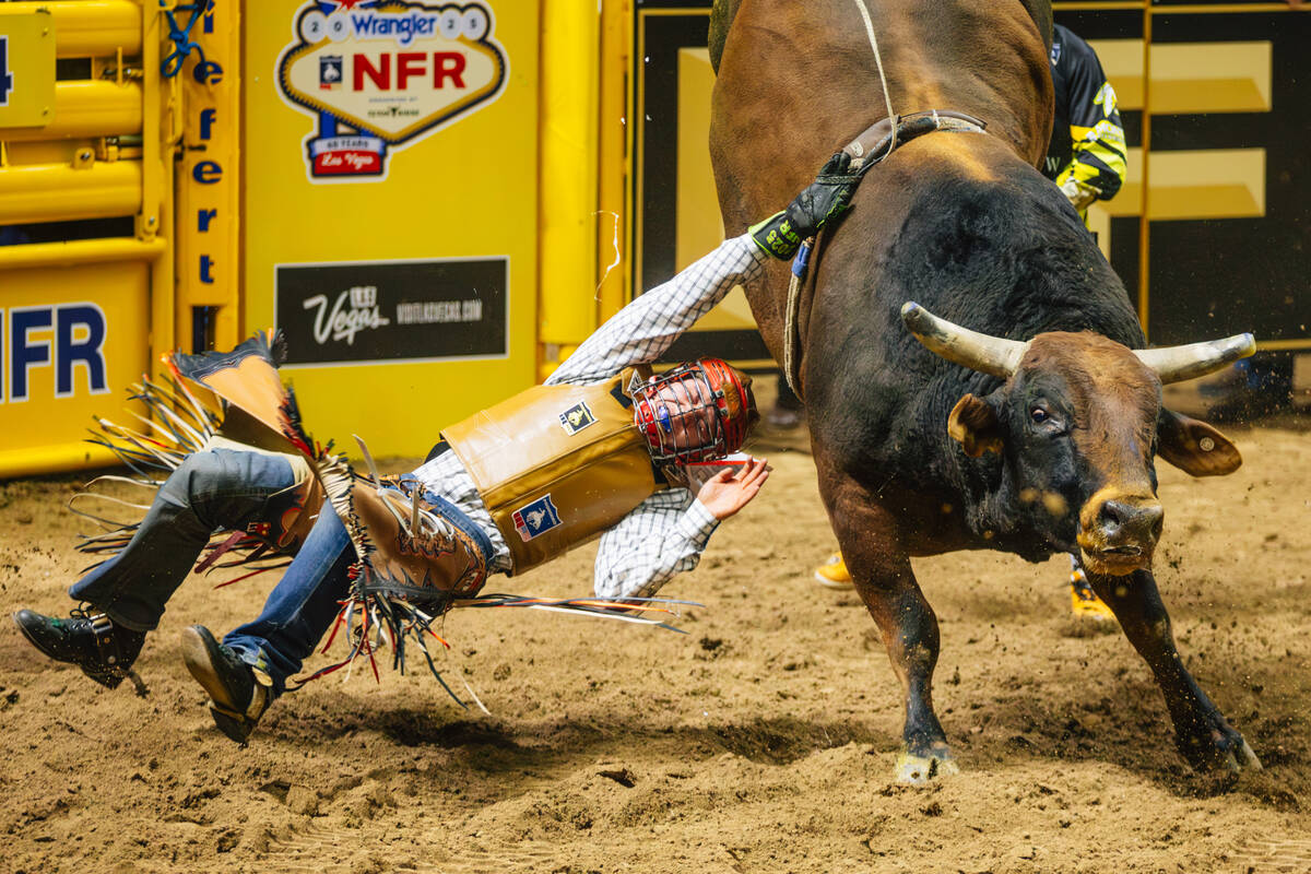 Luke Mackey falls off of Bad News during day three of the National Finals Rodeo at the Thomas & ...