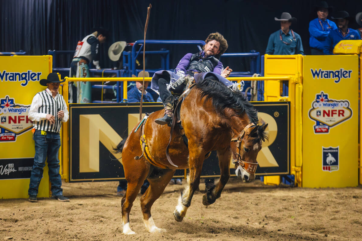 Tilden Hooper rides Square Bale on day four of the National Finals Rodeo at the Thomas & Ma ...
