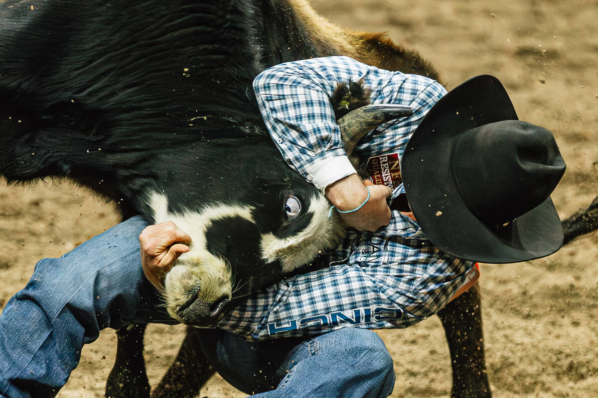Tucker Allen wrestles down a steer on day four of the National Finals Rodeo at the Thomas & ...