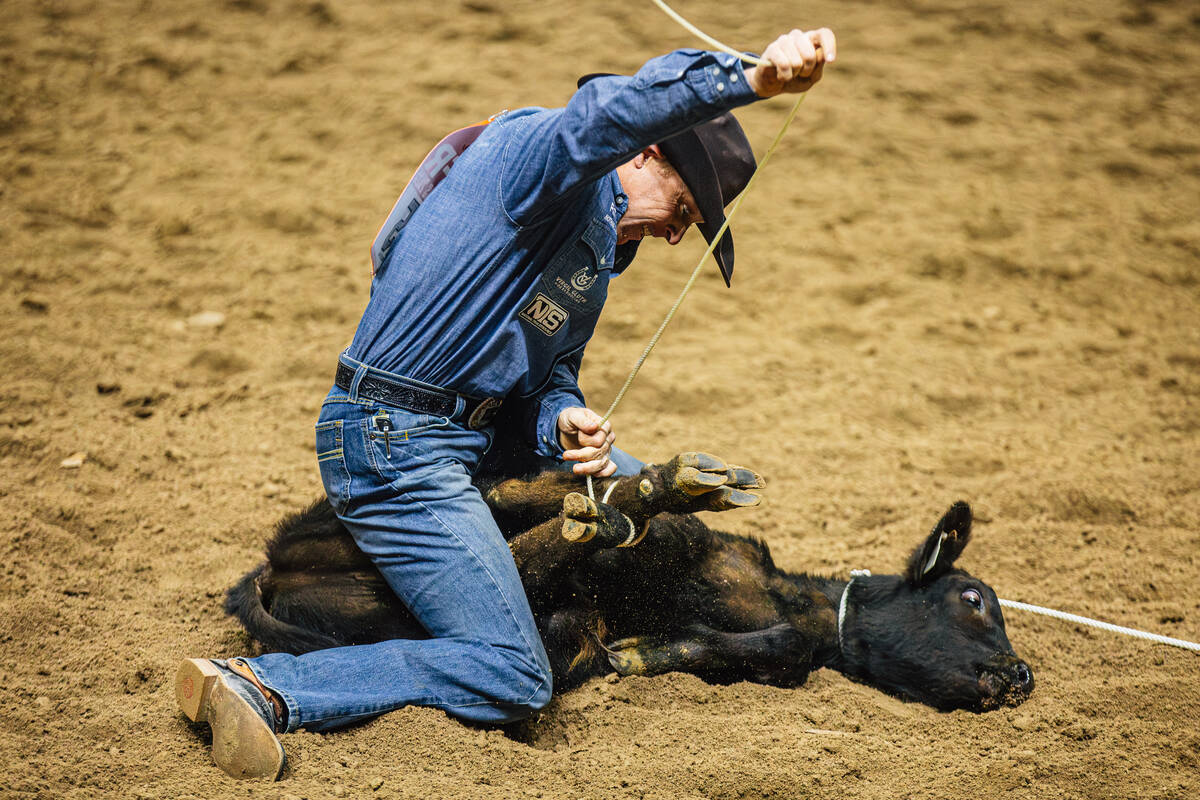 Riley Pruitt ties a calf on day four of the National Finals Rodeo at the Thomas & Mack Cent ...