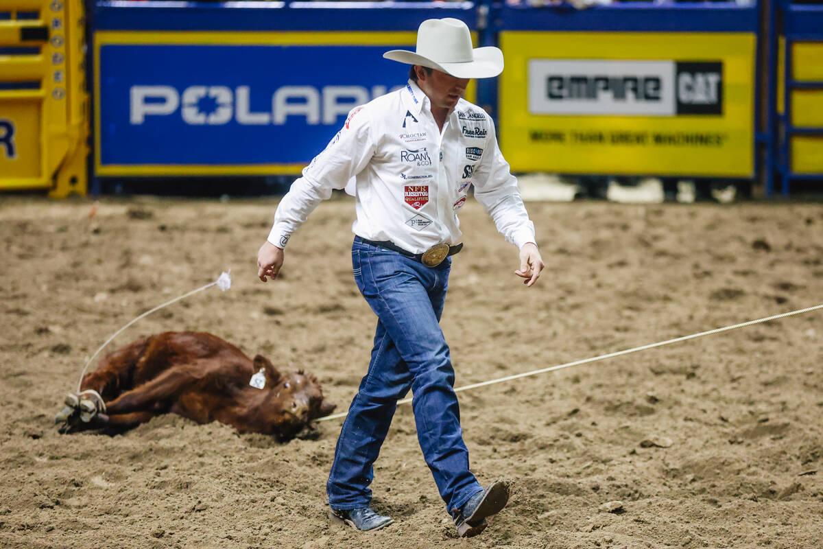 Ty Harris walks away from the calf on day four of the National Finals Rodeo at the Thomas & ...