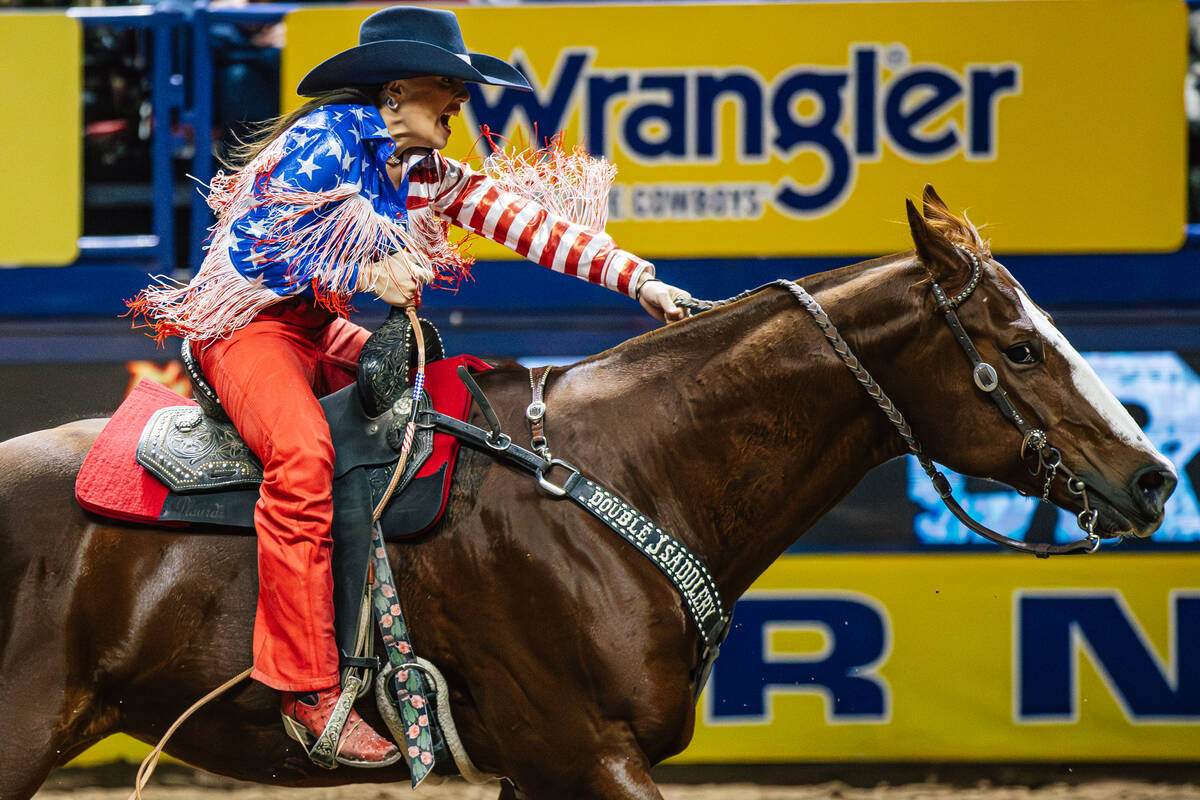 Julie Plourde races into the arena on day four of the National Finals Rodeo at the Thomas & ...
