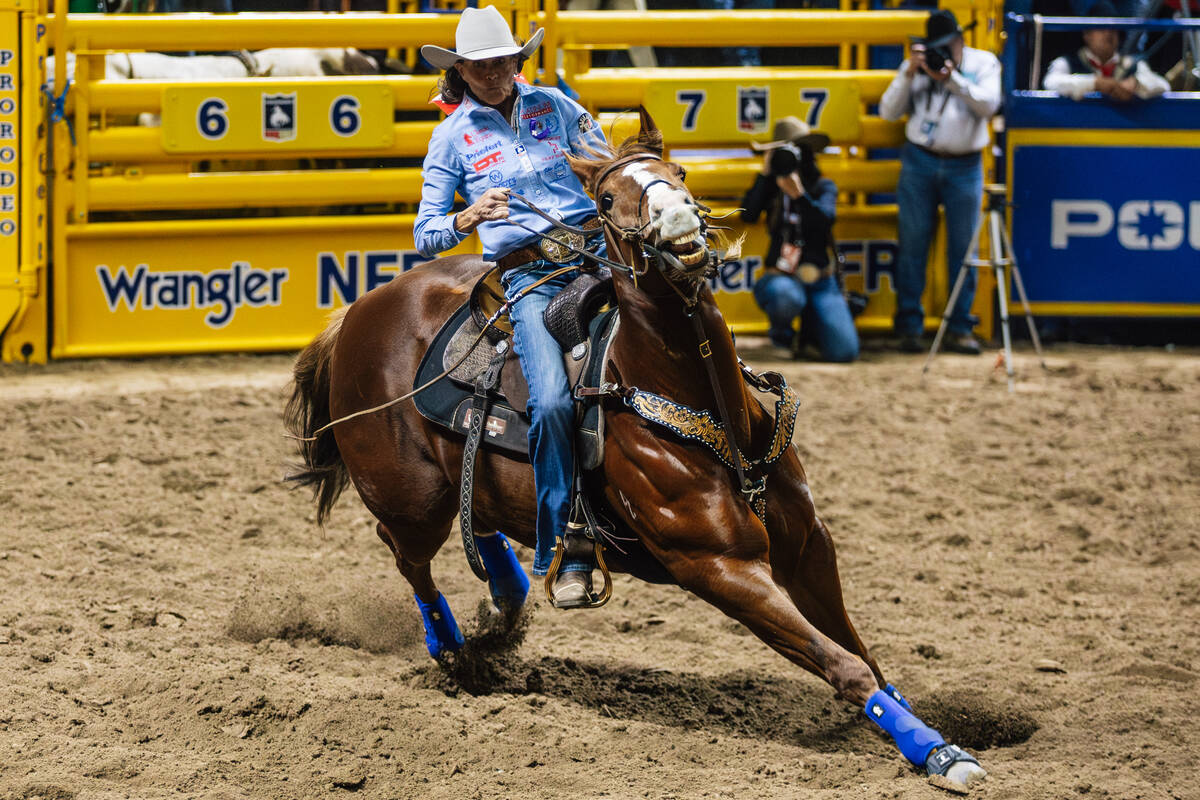 Lisa Lockhart races into the arena on day four of the National Finals Rodeo at the Thomas & ...