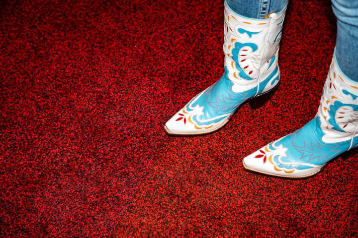 Gracelynn Decker tries on her hat after it was personally fitted for her during Cowboy Christma ...