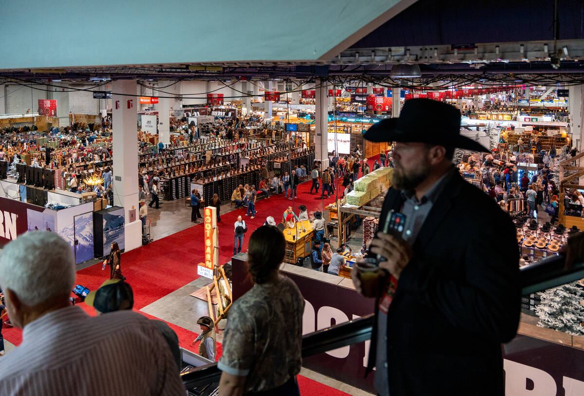 Visitors take the escalator from the second level during Cowboy Christmas at the Las Vegas Conv ...