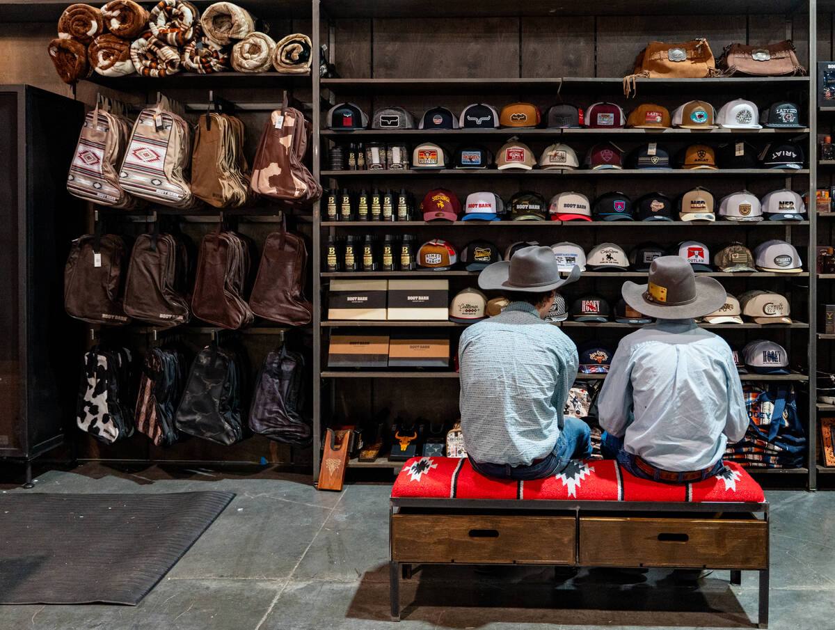 Customers check out hat at the Boot Barn during Cowboy Christmas at the Las Vegas Convention Ce ...