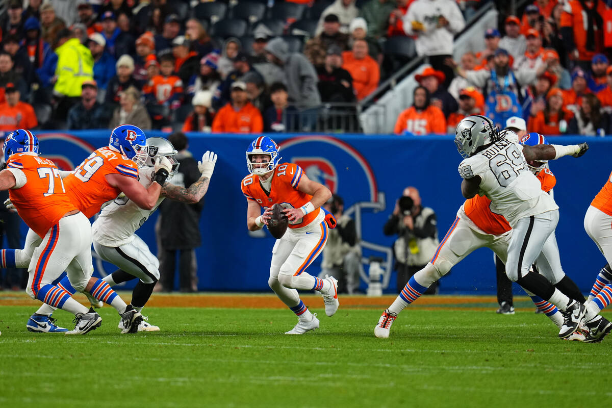 Denver Broncos quarterback Bo Nix (10) runs against the Las Vegas Raiders during an NFL footbal ...