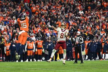 Denver Broncos outside linebacker Nik Bonitto (15) blocks a pass attempt by Washington Commande ...